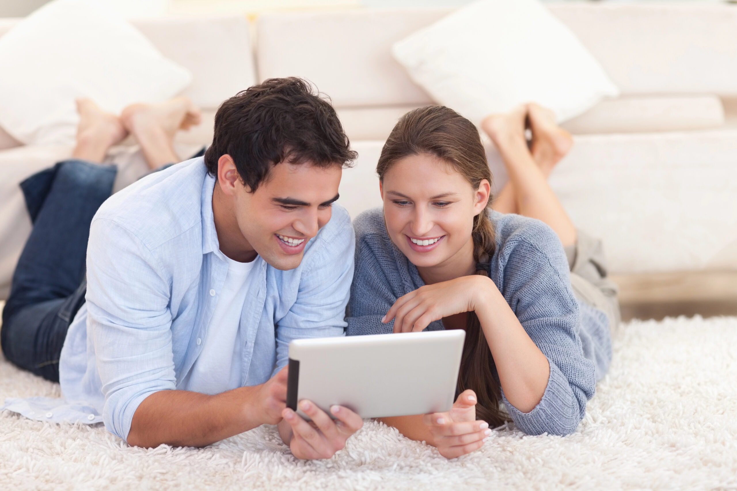 Smiling couple using a tablet computer